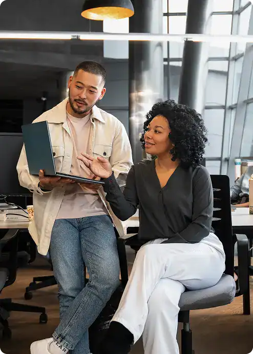 Two professionals collaborating in a modern office environment.
