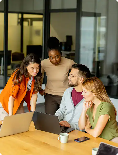 Team of diverse professionals collaborating on a project in a modern office.