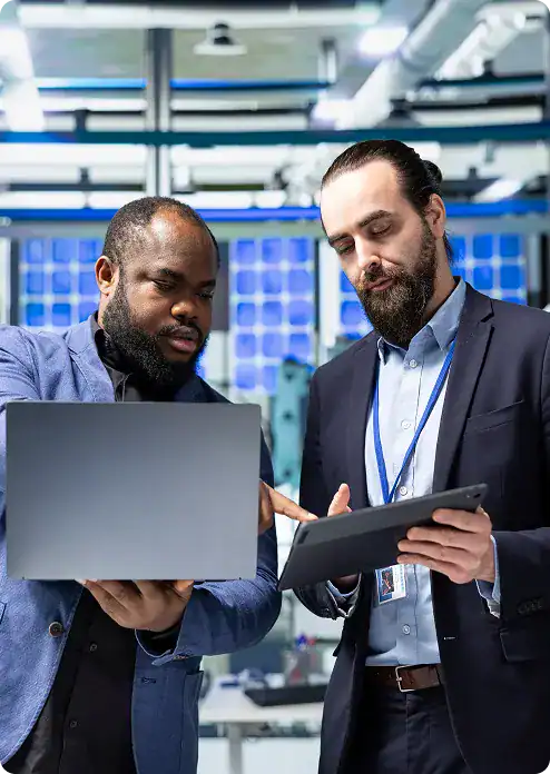 Two professionals discussing technology solutions in a modern office setting.