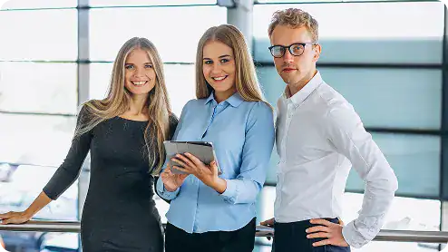 Professional team at i3solutions corporate office with digital devices.