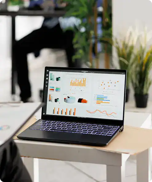 Business analytics dashboard on a laptop screen showing charts and graphs.
